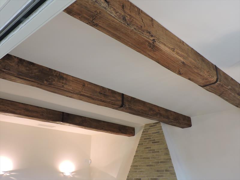 Ceiling beam cladding with faux antique wood over steel girders
